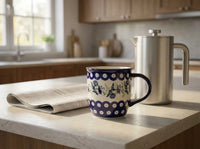 Polish pottery Sweet Annie coffee mug on kitchen counter next to morning newspaper and coffee pot