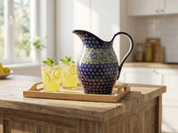 Polish pottery Seaside Swirl Pitcher on wood tray with lemonade on kitchen counter