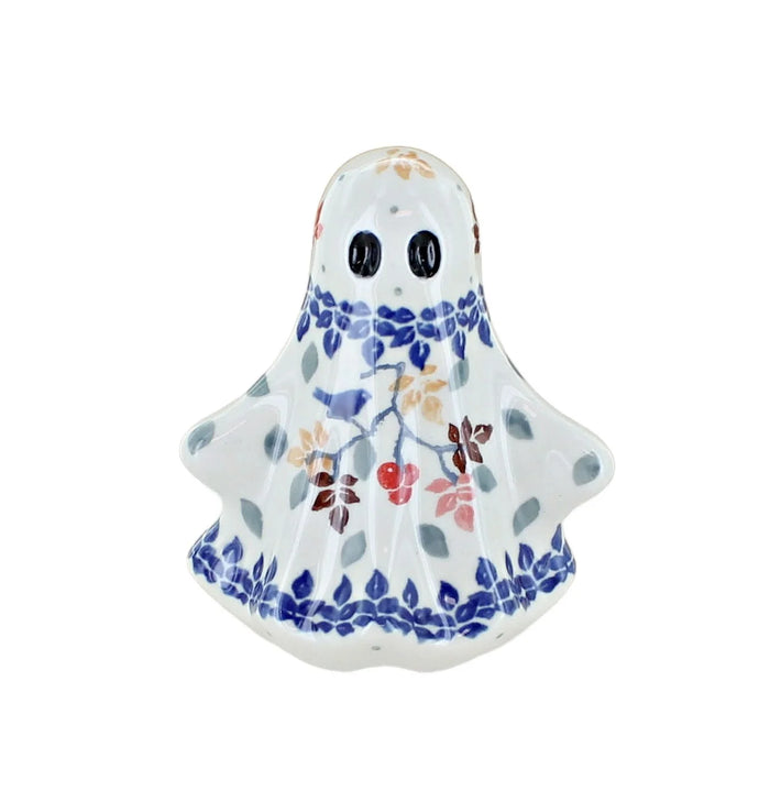 A ceramic ghost figurine with a white glaze, decorated with blue floral borders and small multicolored berries, on a solid white background.