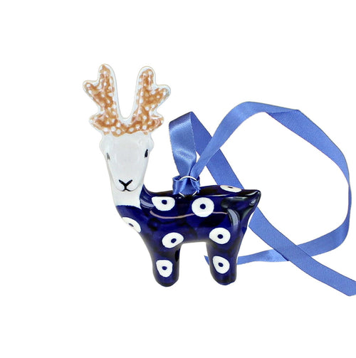 A ceramic Christmas ornament shaped like a deer, featuring a white head with brown antlers, a dark blue body with white polka dots, and a blue ribbon hanger, shown on a plain white background.