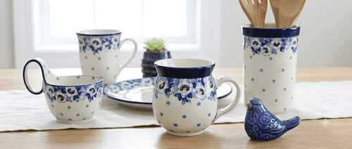 An assortment of Georgia Blue polish pottery on a clean, styled, kitchen background