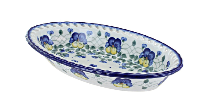 An oval ceramic serving dish with a blue and green floral pattern on a white background, isolated on a white backdrop.