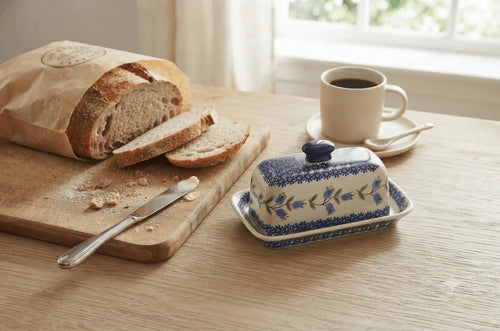 tulip butter dish with fresh bakery bread and coffee mug