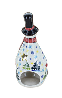 A ceramic snowman figurine with a black top hat, red scarf, and a white body decorated with colorful Christmas trees, snowflakes, and stars, set against a plain white background.