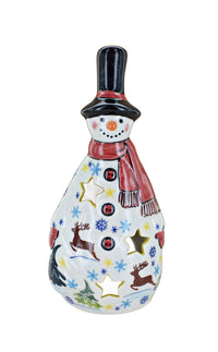 A ceramic snowman figurine with a black top hat, red scarf, and a white body decorated with colorful star, snowflake, reindeer, and tree cutouts, shown on a plain white background.