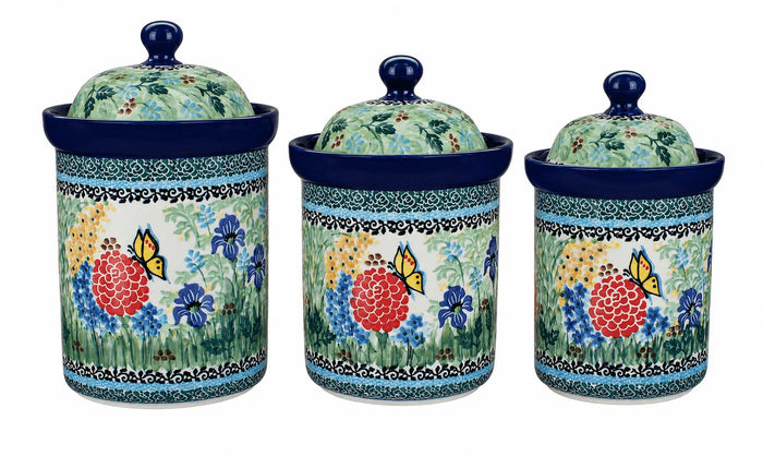Three ceramic canisters with matching lids, decorated with a colorful floral and butterfly pattern on a white background.