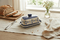 Polish pottery tulip butter dish on a linen table runner with bread and butter
