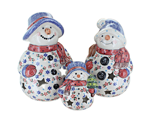 Three ceramic snowman figurines in different sizes, decorated with blue and red patterns, scarves, and hats on a plain white background.